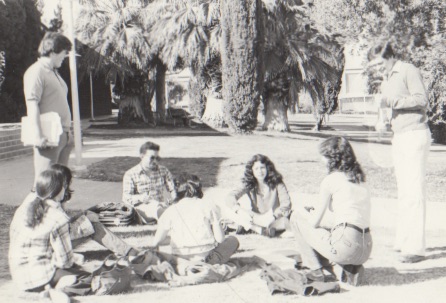 70s Students hanging out in a circle in the grass